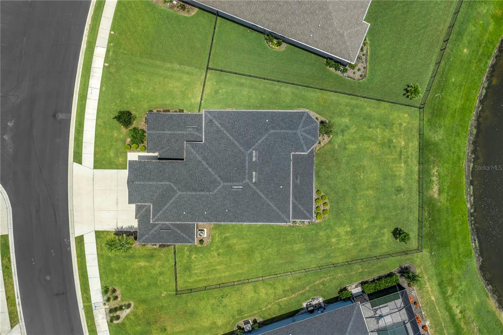 An aerial view shows a house with a dark roof centered on a large lot — 11133 FIELDSTONE DRIVE, PALMETTO, FL