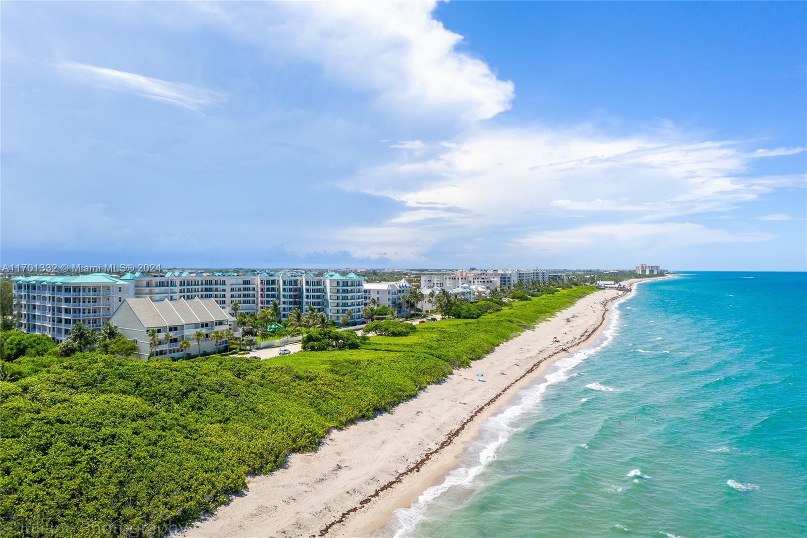 An aerial view shows a sandy beach, lush vegetation, and multi-story residential buildings — 3000 S Highway A1a # 302, Jupiter FL 33477, JUPITER, FL