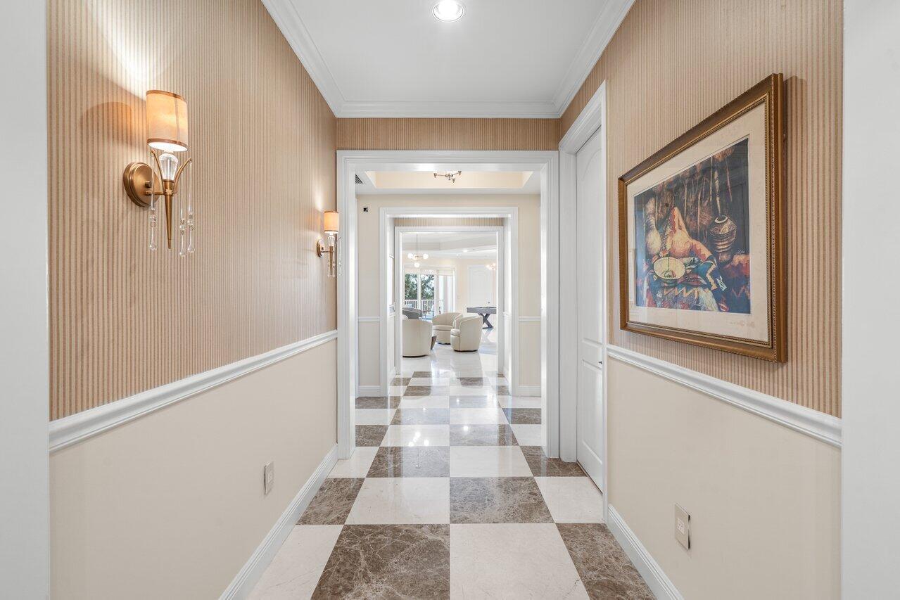 A hallway with striped wallpaper, a checkered marble floor, and a framed painting on the wall — 3000 S Highway A1a # 302, Jupiter FL 33477, JUPITER, FL