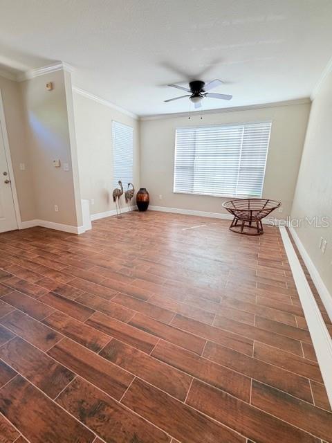 A room with wood-look tile flooring, a ceiling fan, and a round wicker chair — 9108 LAKE CHASE ISLAND WAY UNIT 9108, TAMPA, FL