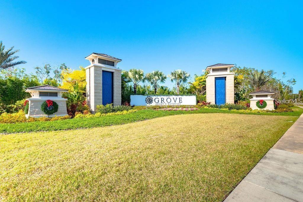 The entrance sign for The Grove Resort & Waterpark stands in a landscaped grassy area — 14501 GROVE RESORT AVENUE UNIT 1440, WINTER GARDEN, FL