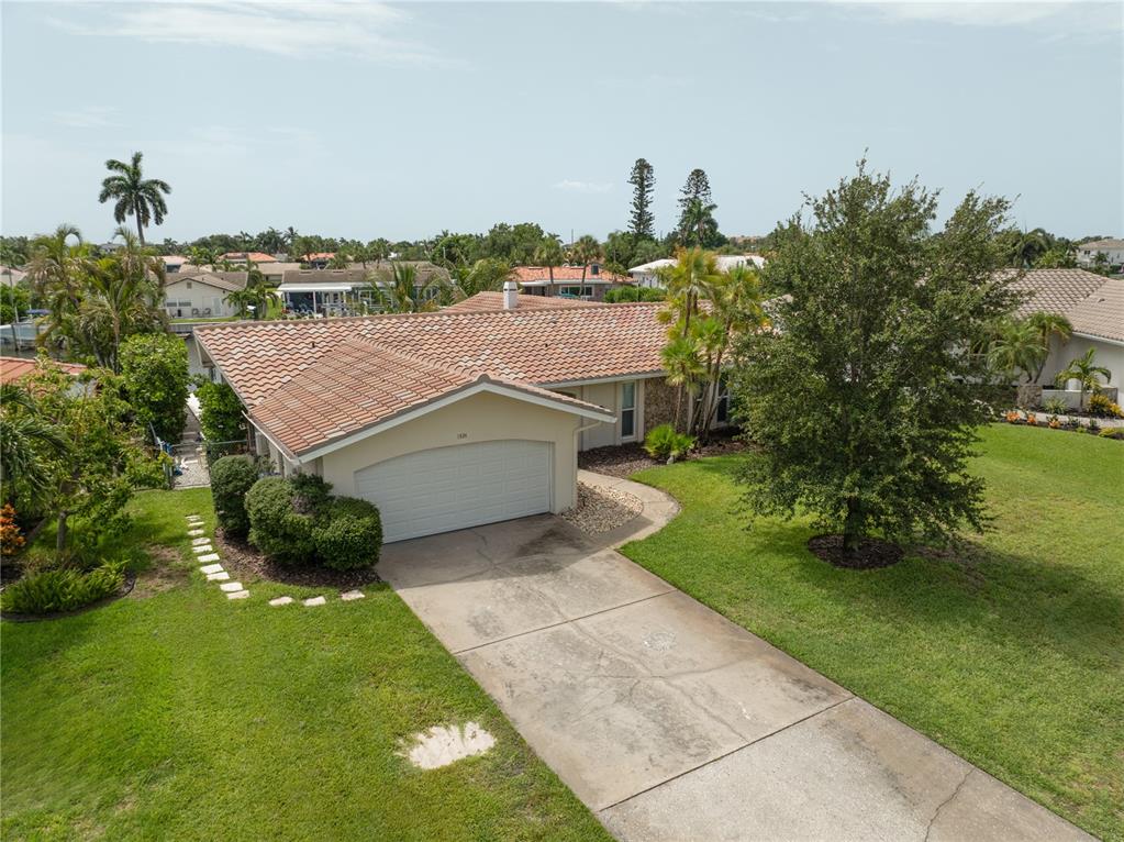 An aerial view of a single-story house with a tile roof and a concrete driveway — 1924 MICHIGAN AVENUE NE, ST PETERSBURG, FL