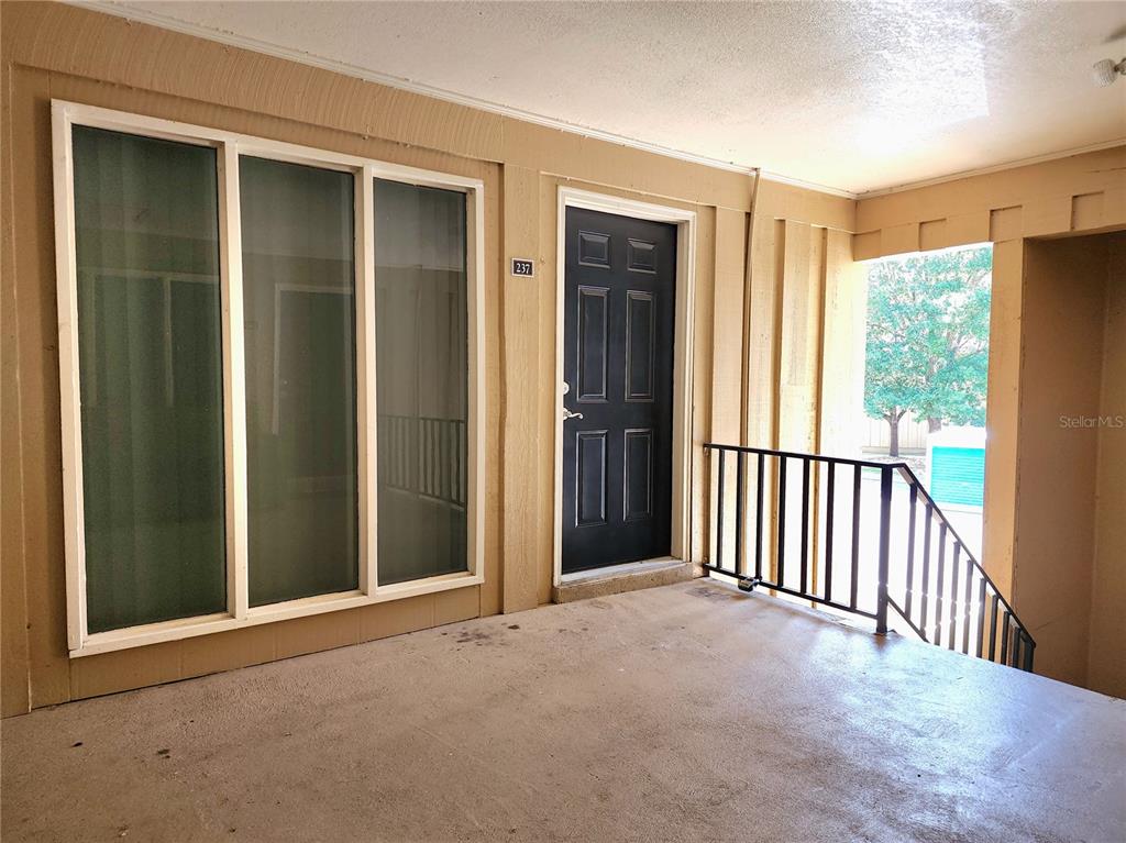 A covered exterior entryway features a dark front door marked 237 and large windows — 507 NW 39TH RD UNIT 237, GAINESVILLE, FL