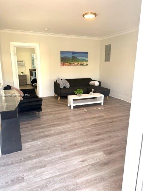 A living room features light wood-look flooring, a dark sofa, and a white coffee table — 345 85 # 1, Miami Beach FL 33141, MIAMI BEACH, FL