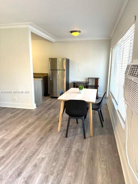 A dining area features a light wood table, black chairs, and a stainless steel refrigerator — 345 85 # 1, Miami Beach FL 33141, MIAMI BEACH, FL