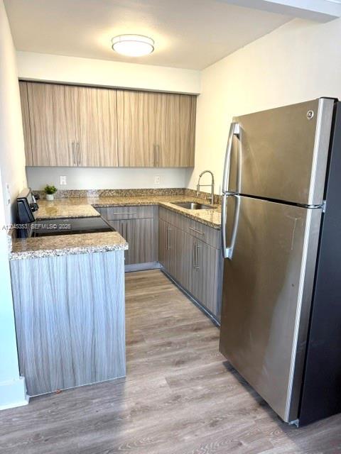 A kitchen features light wood-grain cabinets, granite countertops, and stainless steel appliances — 345 85 # 1, Miami Beach FL 33141, MIAMI BEACH, FL
