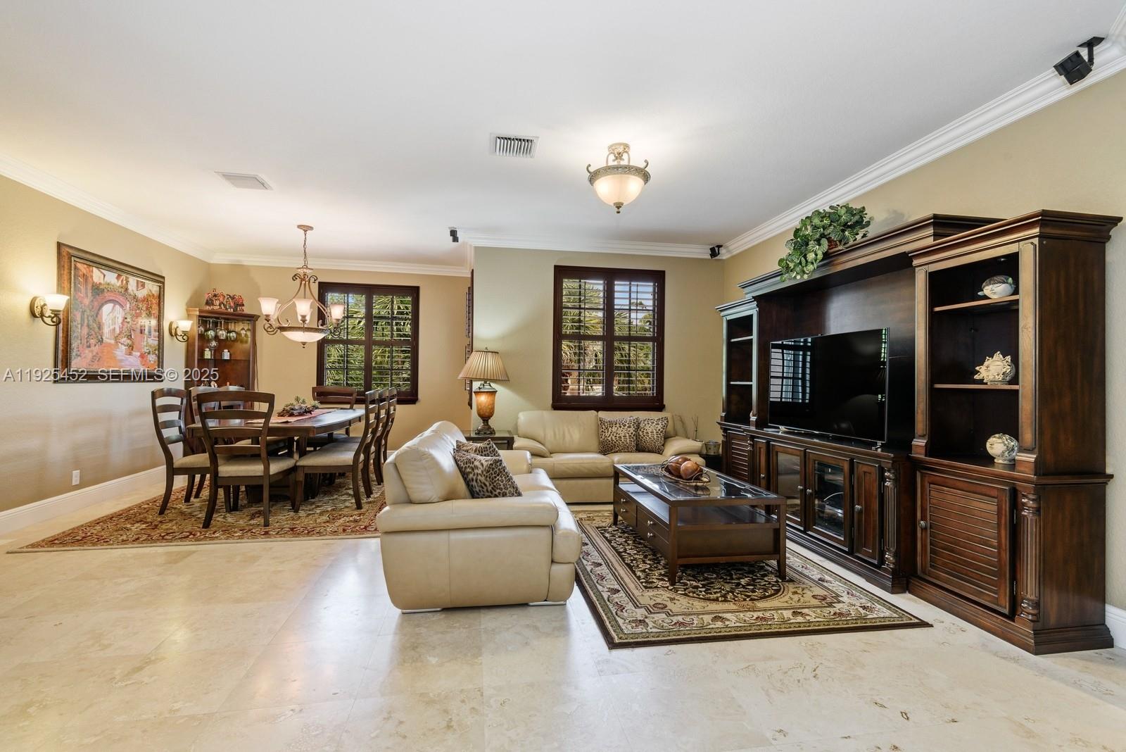 A living and dining room area features beige tile floors, leather sofas, and dark wood furniture — 2782 Kinsington Cir # 4, Weston FL 33332, WESTON, FL