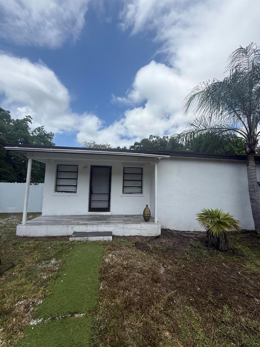 A white, single-story house with a covered front porch and a palm tree — 6315 SW 32nd Street, Miramar FL 33023, MIRAMAR, FL