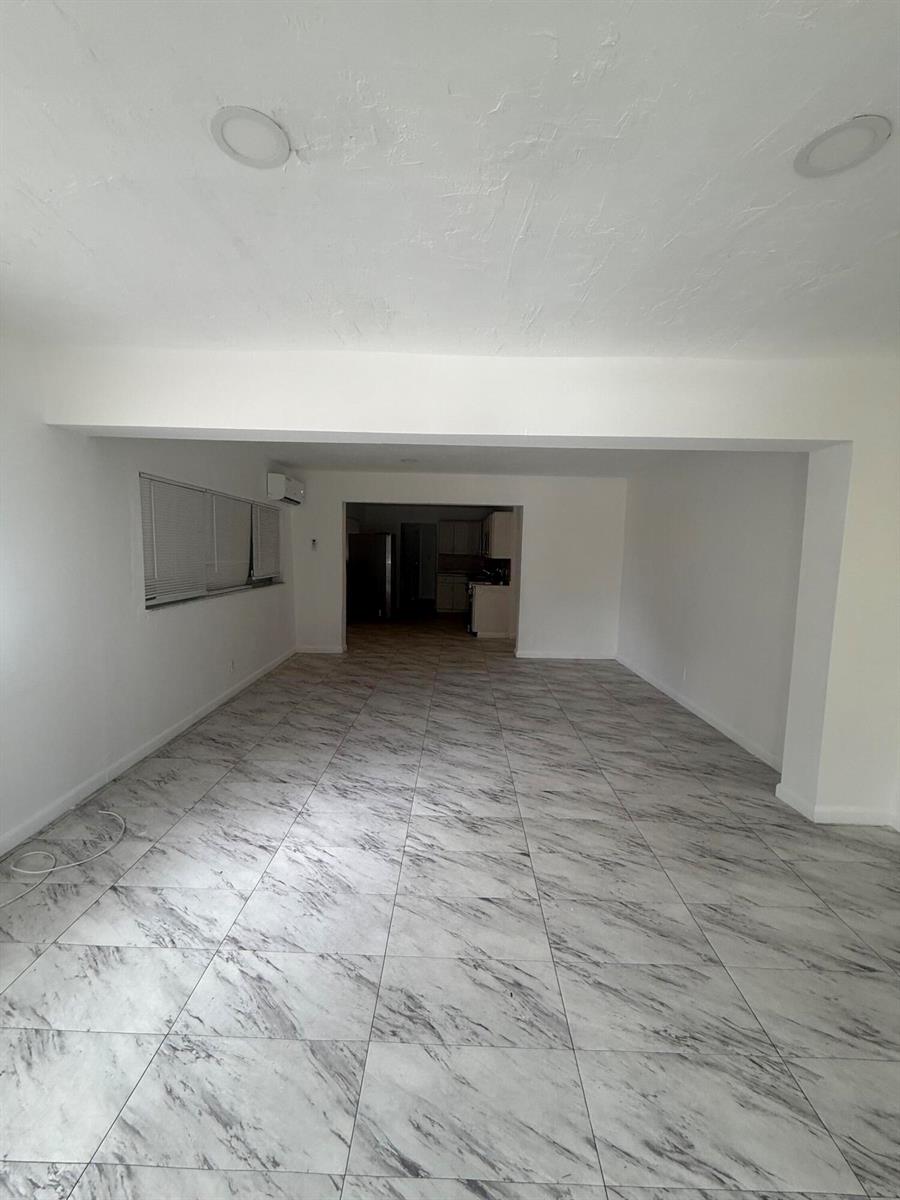 An empty room with white walls and grey-and-white marble-patterned tile flooring — 6315 SW 32nd Street, Miramar FL 33023, MIRAMAR, FL