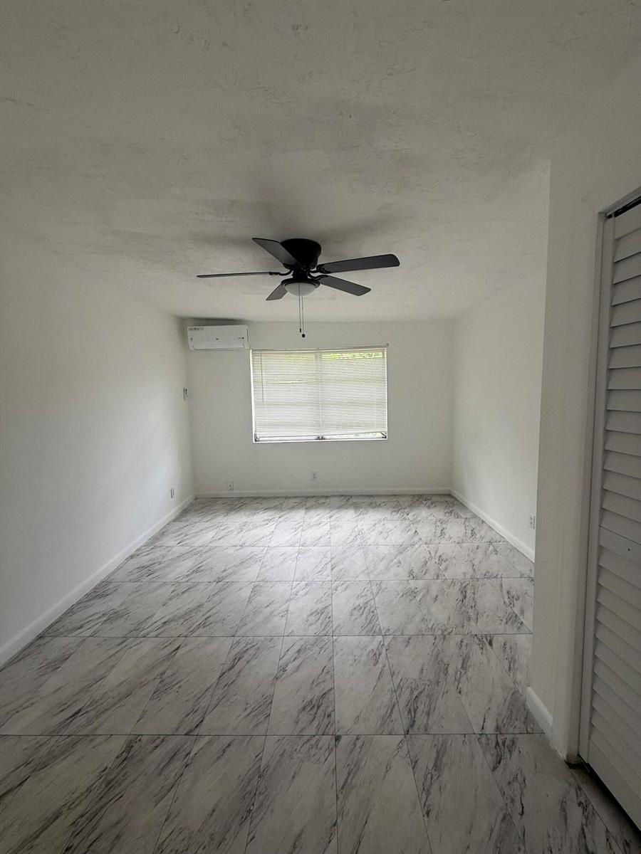 An empty room features white walls, a ceiling fan, and light-colored marble-patterned tile flooring — 6315 SW 32nd Street, Miramar FL 33023, MIRAMAR, FL