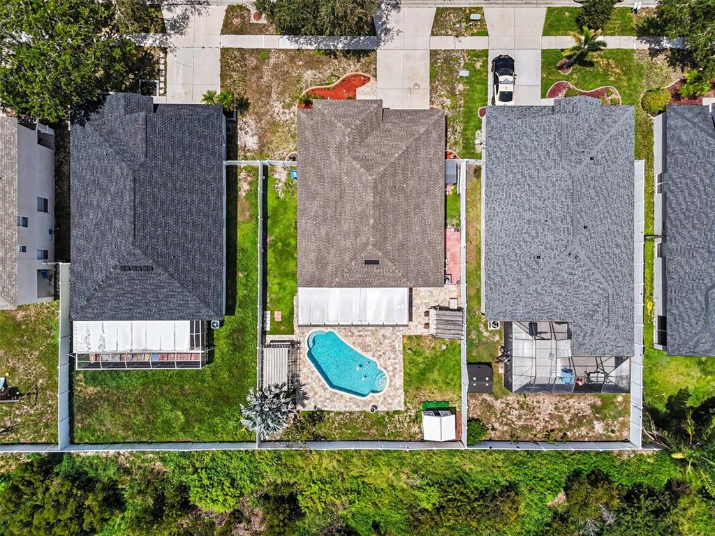 An aerial view shows three residential houses with backyards, one featuring a swimming pool — 11531 MISTY ISLE LANE, RIVERVIEW, FL
