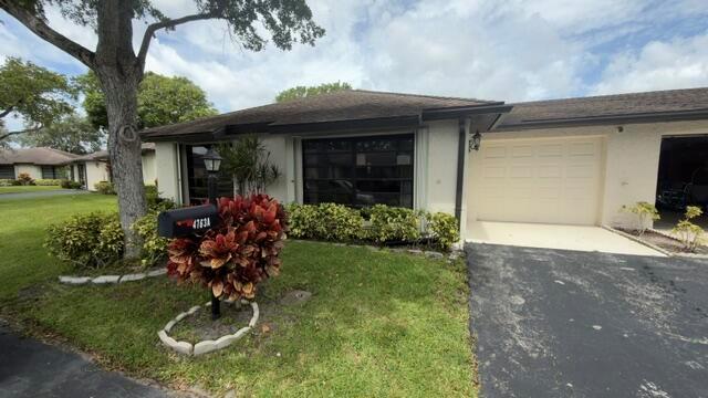 A single-story house with a white exterior, a garage, and a landscaped front yard — 4763 Storkwood Terrace # A, Boynton Beach FL 33436, BOYNTON BEACH, FL