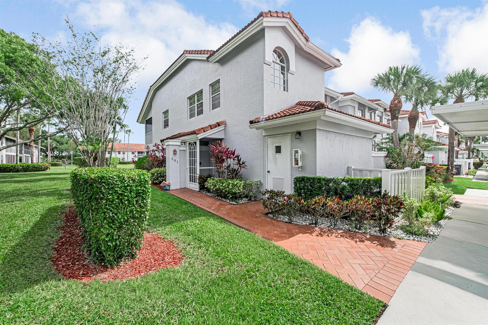 A two-story gray stucco townhouse with a red tile roof and brick walkway — 7384 Lake Meadow Way # 201, Boynton Beach FL 33437, BOYNTON BEACH, FL