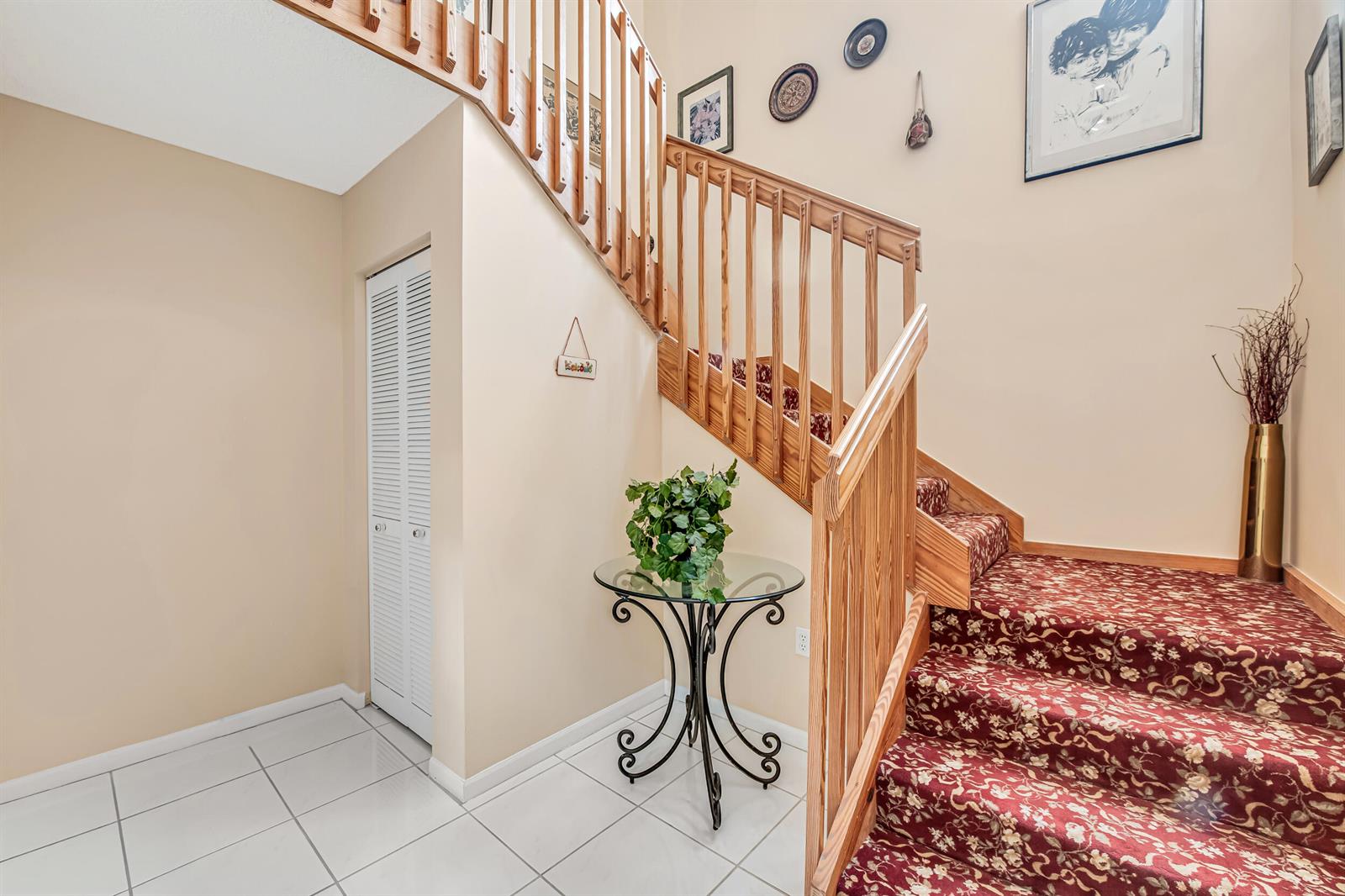 A foyer features a white tiled floor, a glass-topped table, and carpeted stairs with railings — 7384 Lake Meadow Way # 201, Boynton Beach FL 33437, BOYNTON BEACH, FL