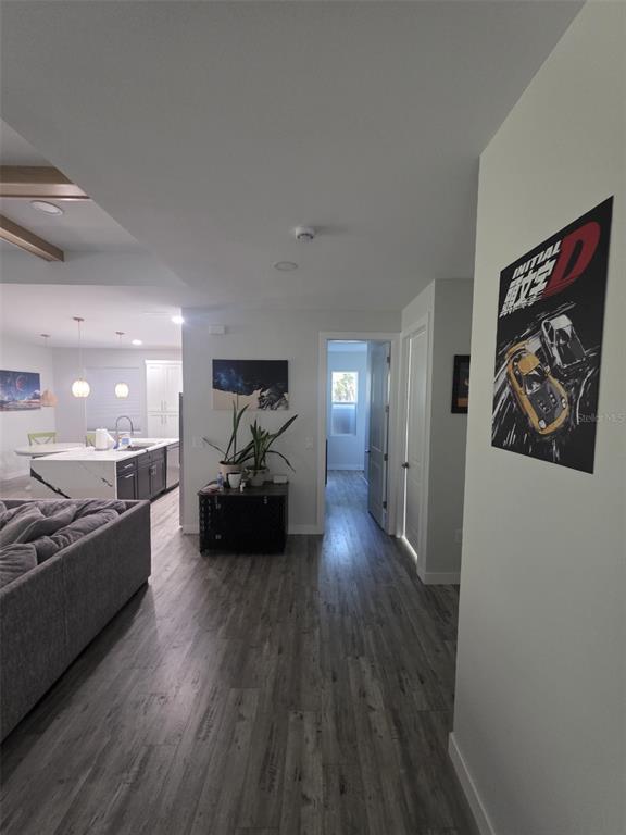 An interior view shows a living area, kitchen with island, and a hallway with flooring — 1259 KAAYAN STREET, NORTH PORT, FL