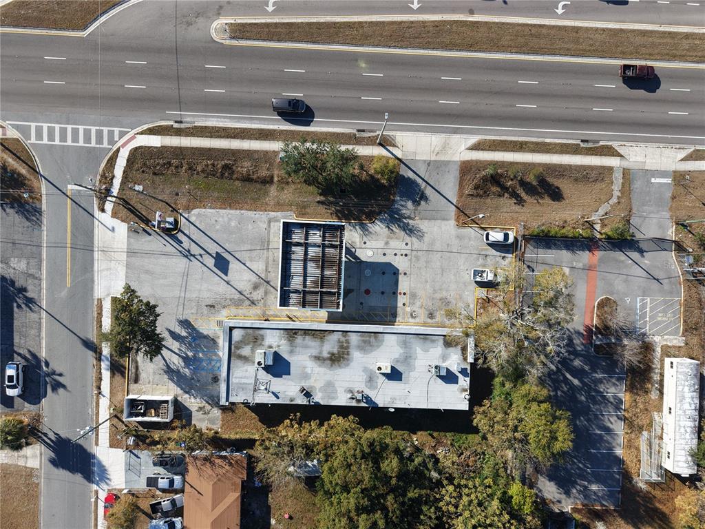 Aerial view of a commercial property with a gas station canopy and a parking lot — 8431 E COLONIAL DRIVE, ORLANDO, FL