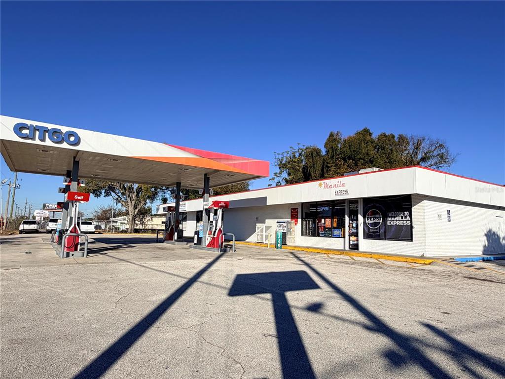 A Citgo gas station with a Manila Express convenience store under a large canopy — 8431 E COLONIAL DRIVE, ORLANDO, FL