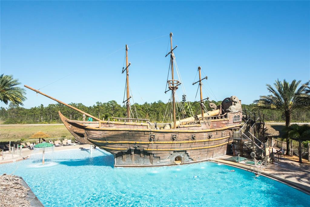 A large pirate ship play structure sits in the middle of a swimming pool — 8112 POINCIANA BOULEVARD UNIT 1802, ORLANDO, FL