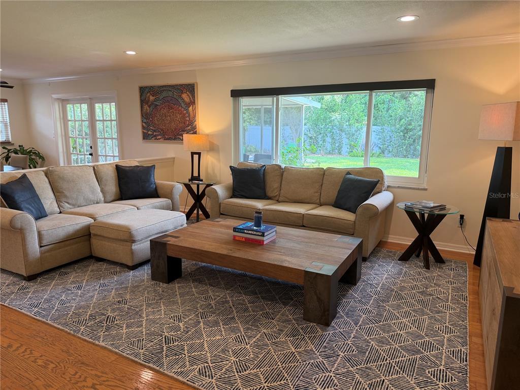 A living room features two beige sofas, a wooden coffee table, and a geometric rug — 810 SWEETBRIAR ROAD, ORLANDO, FL