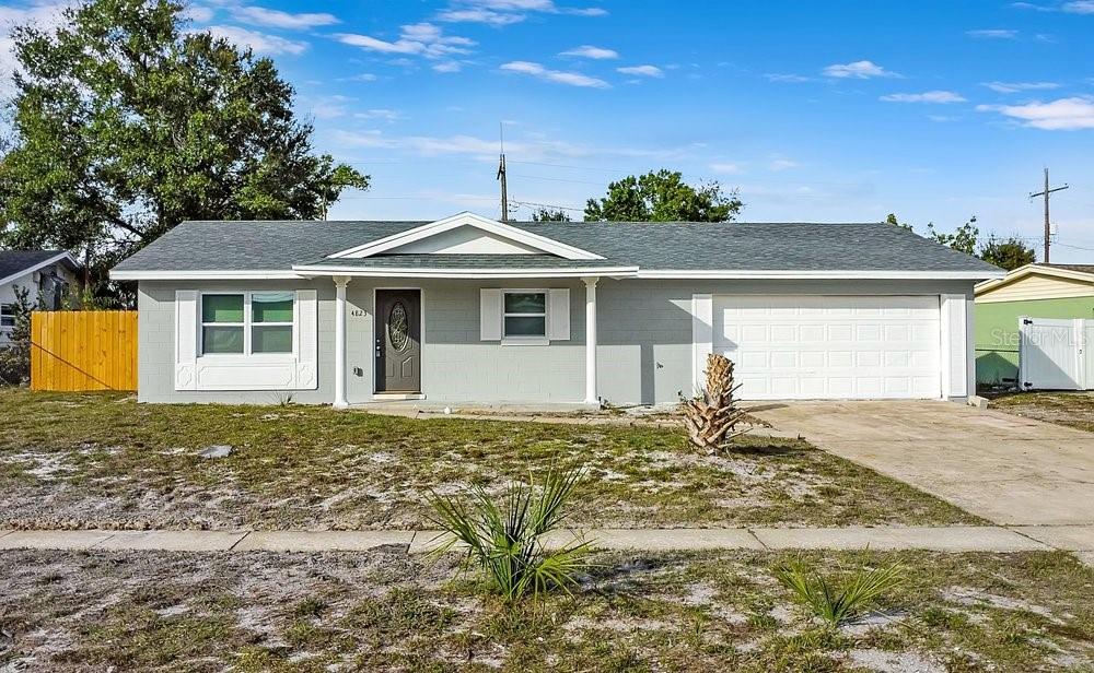 A single-story house with a gray exterior, white trim, and an attached two-car garage — 4823 KATHY JO TERRACE, ORLANDO, FL