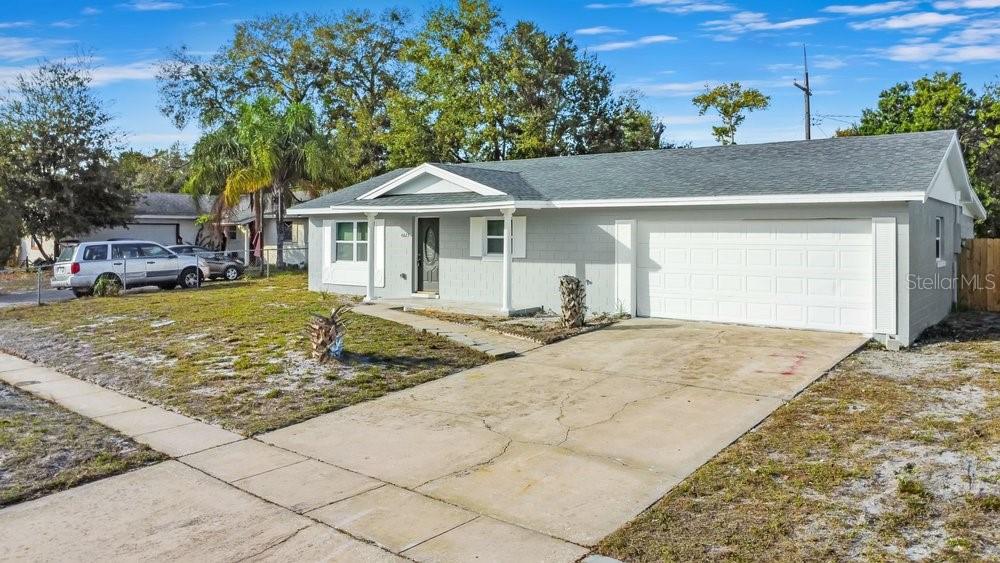 A single-story gray house with a two-car garage and a concrete driveway — 4823 KATHY JO TERRACE, ORLANDO, FL
