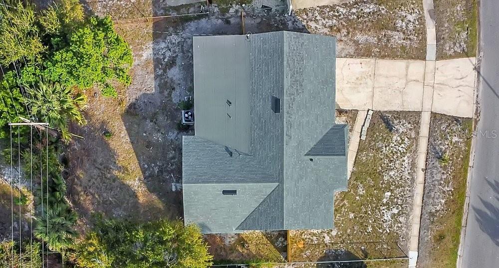 An aerial view shows a house with a green shingled roof and a concrete driveway — 4823 KATHY JO TERRACE, ORLANDO, FL