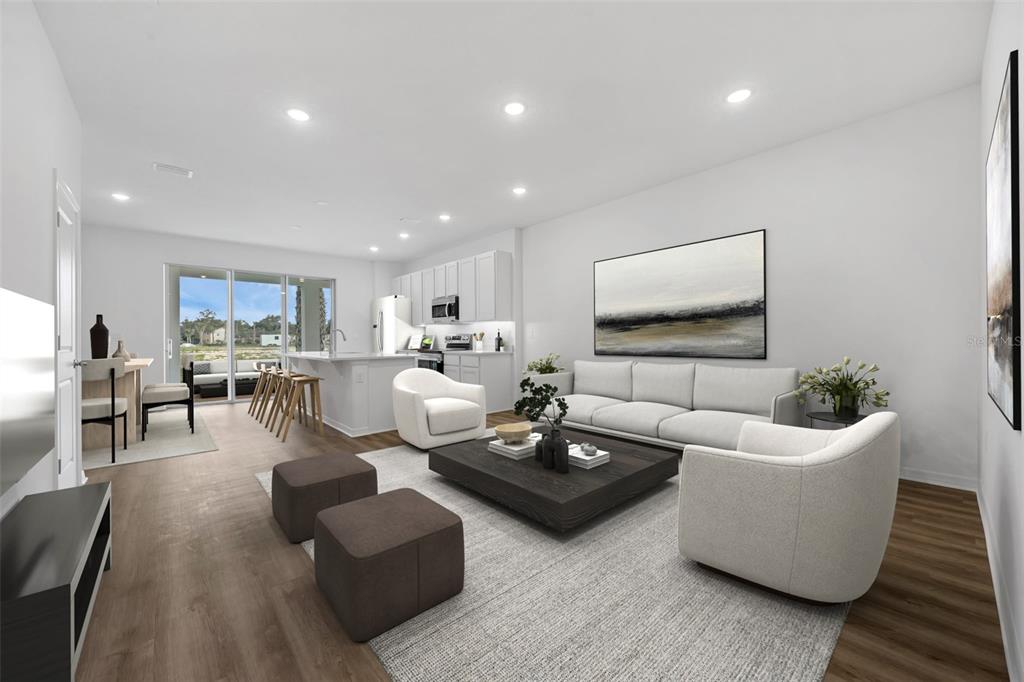 This is a digital rendering of an open-concept living room and kitchen with white cabinetry — 1156 CYPRESS ELM DRIVE, DELAND, FL