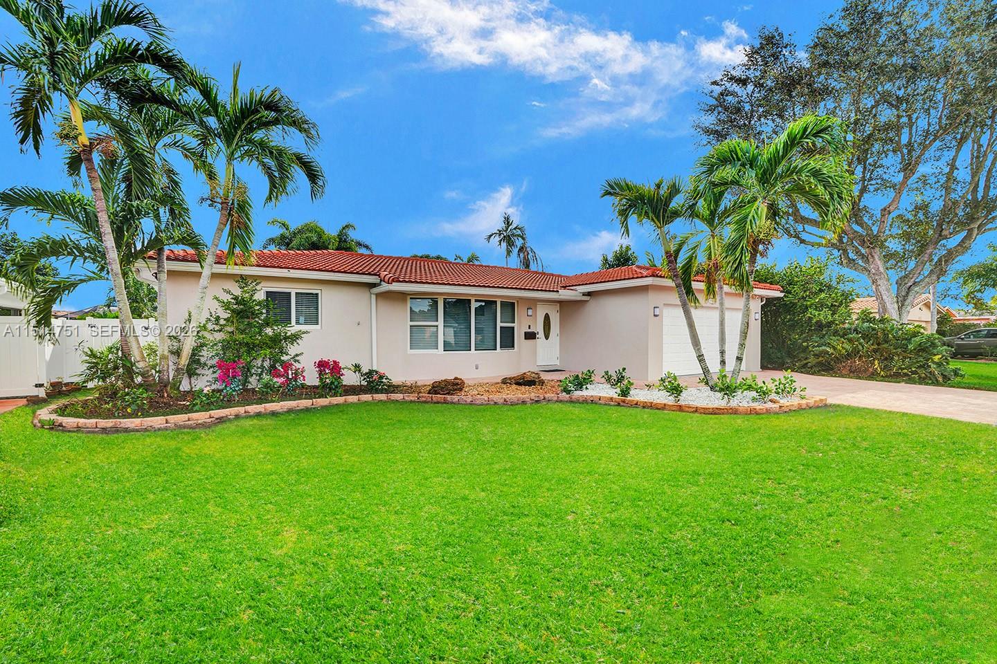 A single-story house with a red tile roof, palm trees, and a green lawn — 5500 Cleveland St, Hollywood FL 33021, HOLLYWOOD, FL