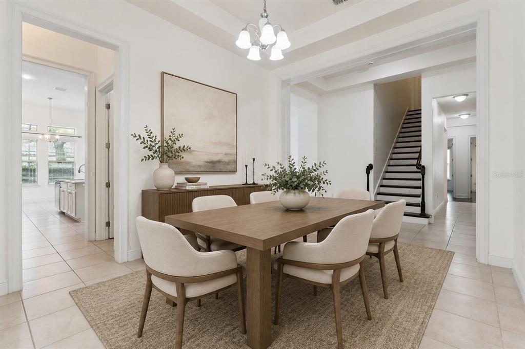 A dining room features a wooden table, six upholstered chairs, and a sideboard under artwork — 10370 DOTH STREET, ORLANDO, FL