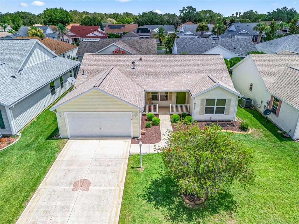An aerial view of a single-story suburban house with a two-car garage and driveway — 3025 HOBART COURT, THE VILLAGES, FL