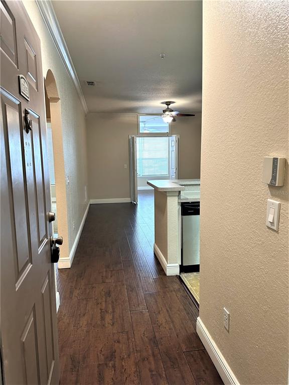 The view from an open doorway shows a hallway leading to a kitchen and living area — 3355 S KIRKMAN ROAD UNIT 1315, ORLANDO, FL