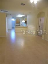 An open-concept living area features light-colored tile flooring and a kitchen with a breakfast bar — 11339 VILLAGE BROOK DRIVE, RIVERVIEW, FL