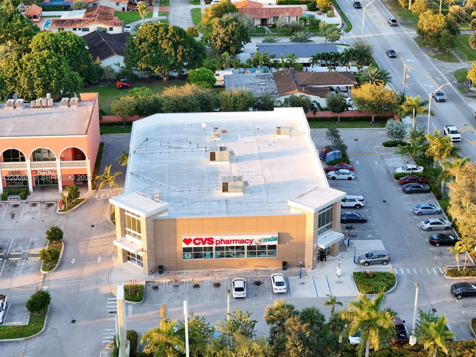 An aerial view shows a CVS Pharmacy building with a parking lot and surrounding neighborhood — 12711 SW 42nd St, Miami FL 33175, MIAMI, FL