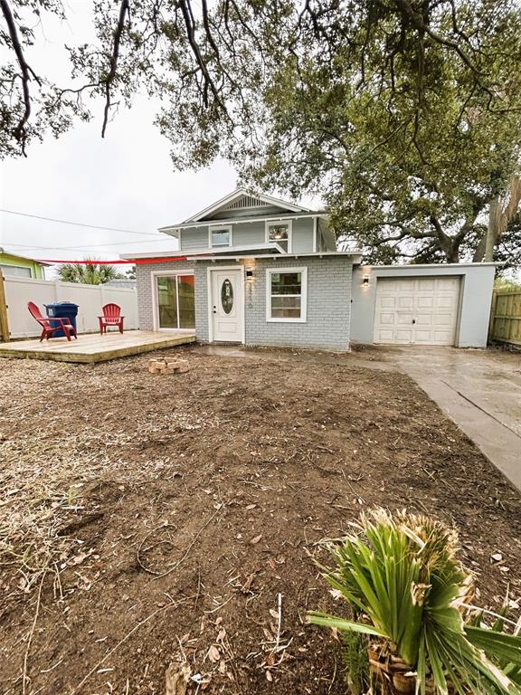 A two-story gray house with a wooden deck, a garage, and a dirt backyard — 2310 21ST STREET S, ST PETERSBURG, FL