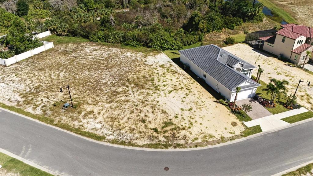 An aerial view shows a vacant residential lot next to a single-story house — 6 RIO VISTA DRIVE, PALM COAST, FL