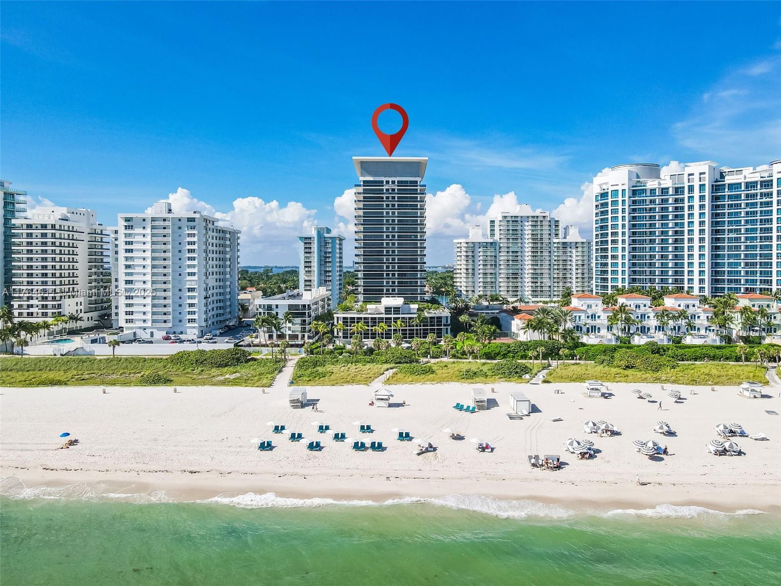 An aerial view shows a tall residential building with a red location pin on the beach — 5875 Collins Ave # 1704, Miami Beach FL 33140, MIAMI BEACH, FL