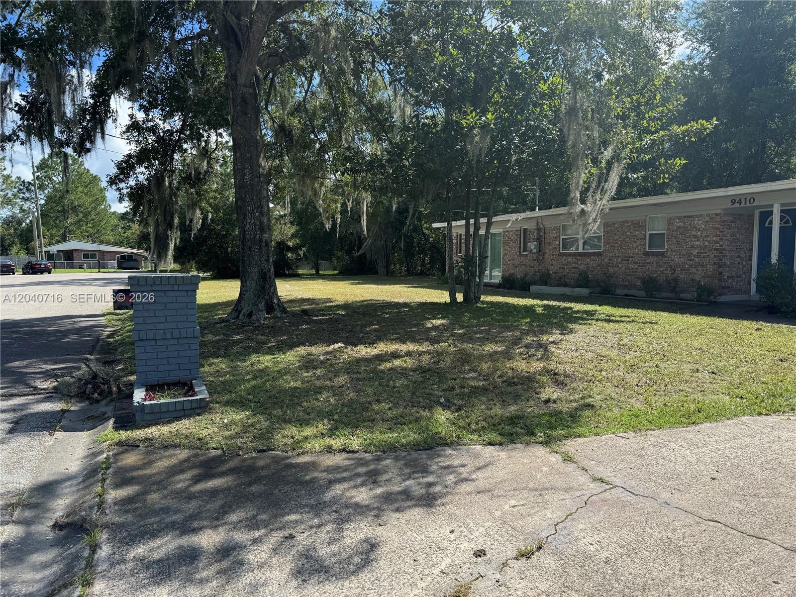 A brick house with a large tree in the front yard and a mailbox — 9410 Gilchrist ct, Jacksonville FL 32219, JACKSONVILLE, FL