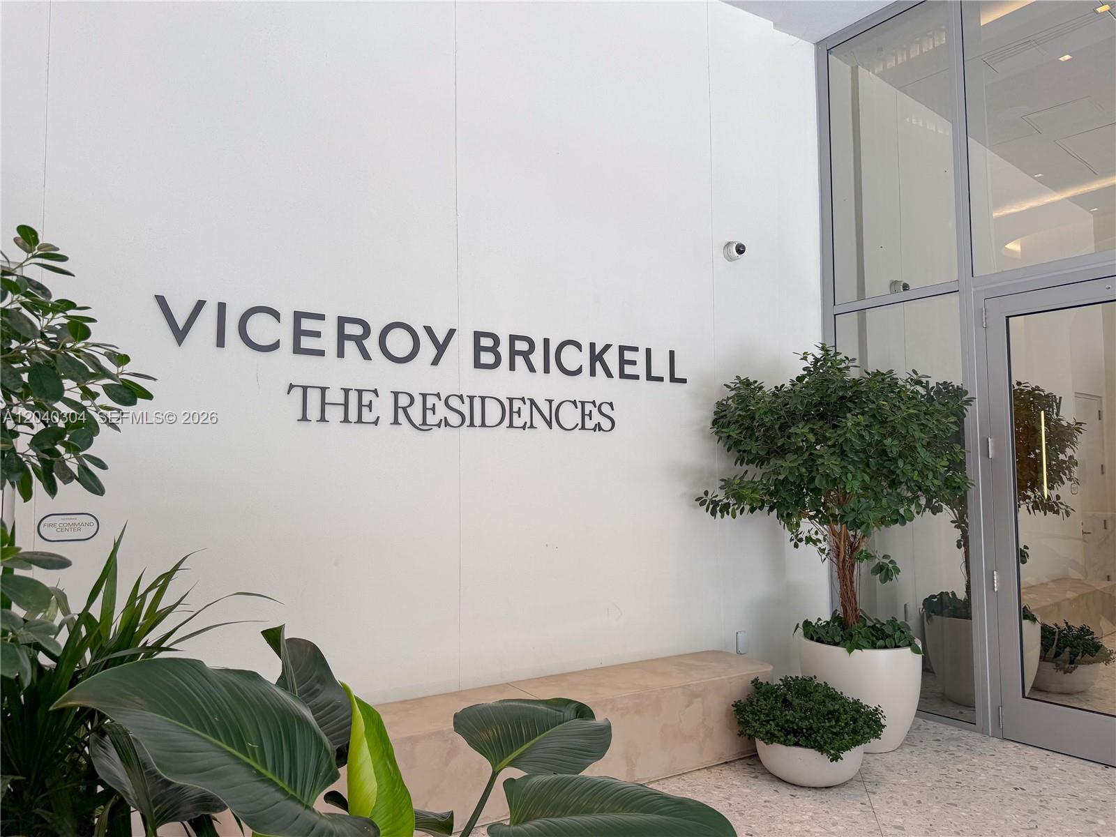 A white wall displays the Viceroy Brickell The Residences sign near a glass entrance door — 77 SE 5 # 4015, Miami FL 33131, MIAMI, FL