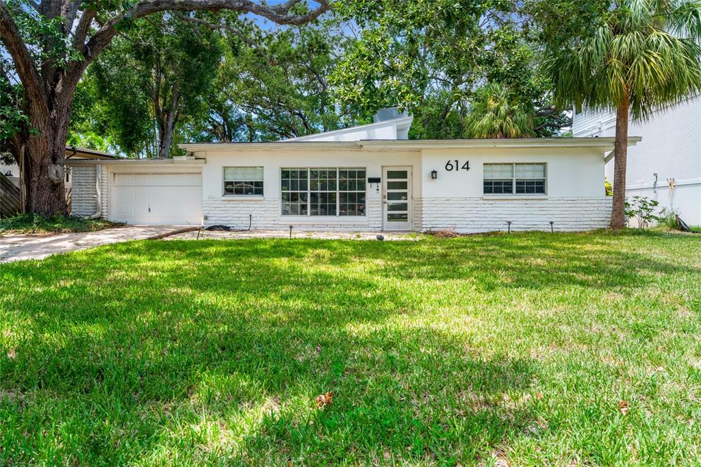 A single-story white brick house with a garage and a large front lawn — 614 ONTARIO AVENUE, TAMPA, FL