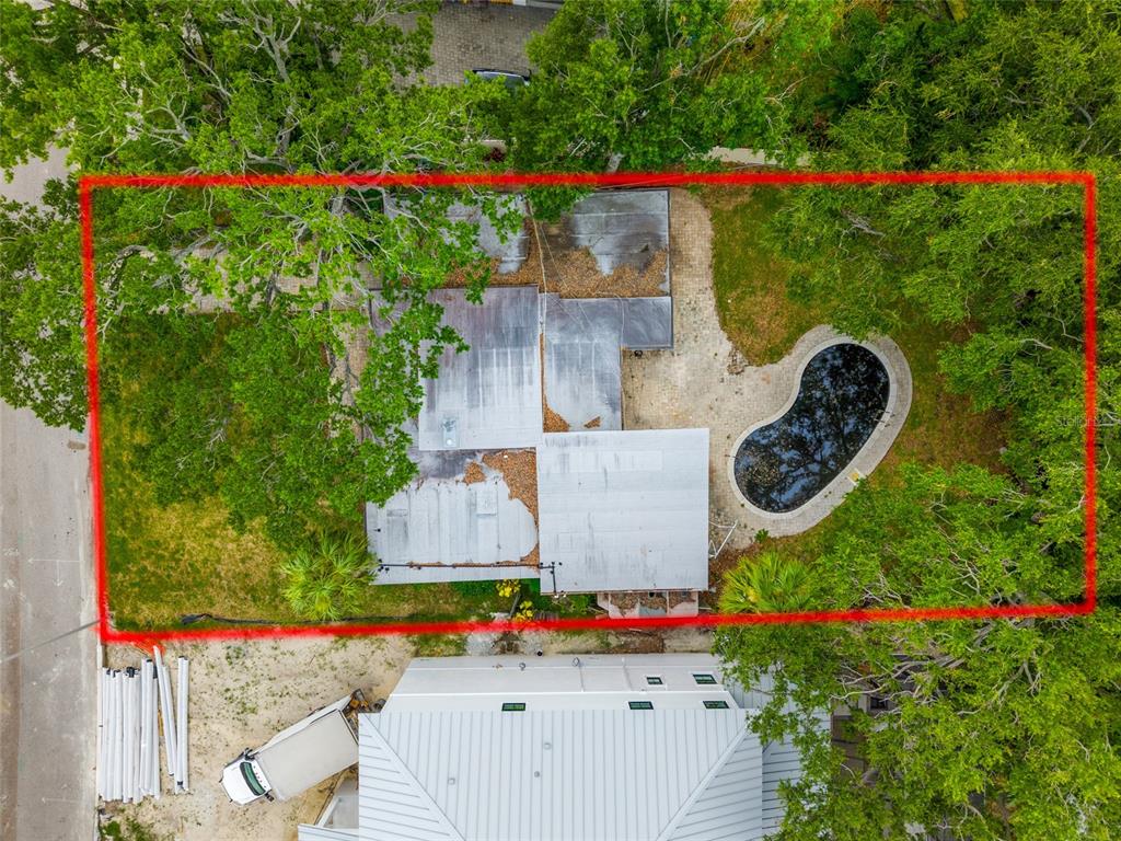 An aerial view shows a house with a flat roof, a pool, and surrounding trees — 614 ONTARIO AVENUE, TAMPA, FL