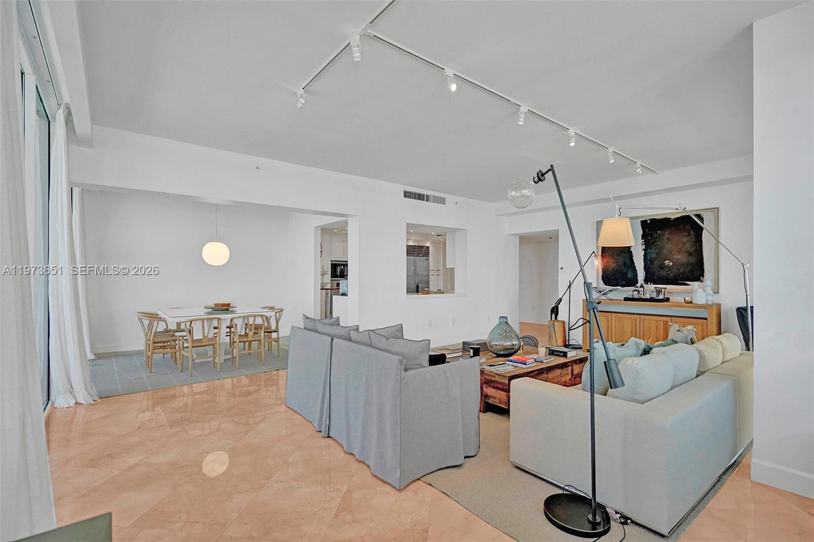 A living room and dining area feature white walls, tile floors, and track lighting — 10205 Collins Ave # P8, Bal Harbour FL 33154, BAL HARBOUR, FL