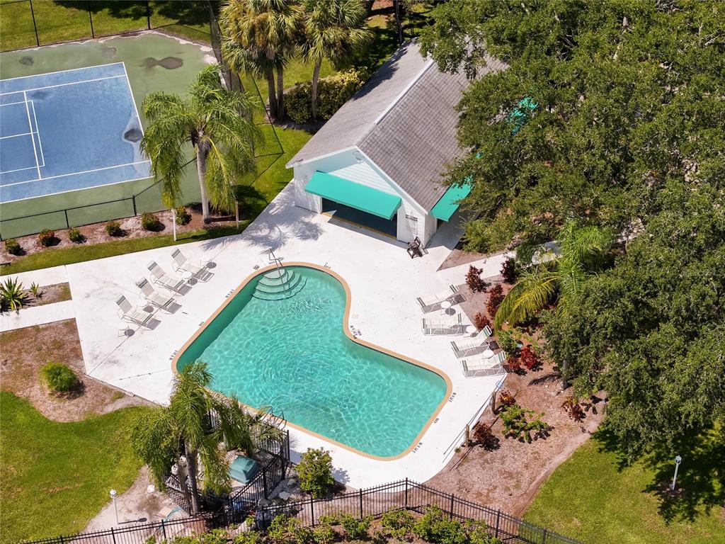 An aerial view shows a swimming pool, a tennis court, and a small building — 7815 GENEVA LANE, SARASOTA, FL