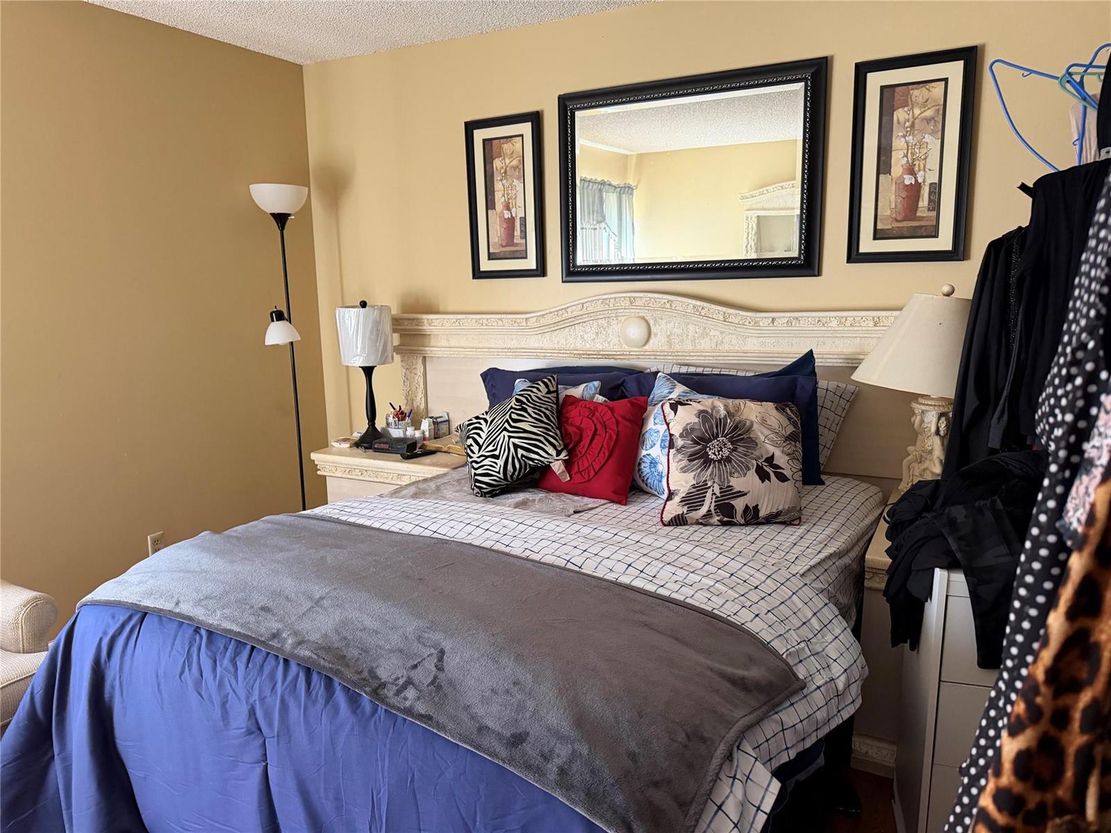 A bathroom features a tan vanity, a beige bathtub, and a blue and white shower curtain — 8620 N Sherman Circle # 204, Miramar FL 33025, MIRAMAR, FL