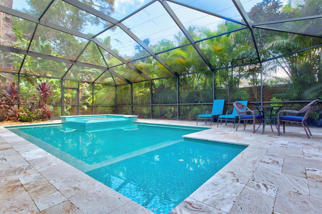 A screened-in swimming pool and hot tub with stone decking and patio furniture — 2729 SYDELLE STREET, SARASOTA, FL