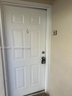 A white front door with a lockbox and the number 110 on the adjacent wall — 6175 NW 186th St # 110, Hialeah FL 33015, HIALEAH, FL