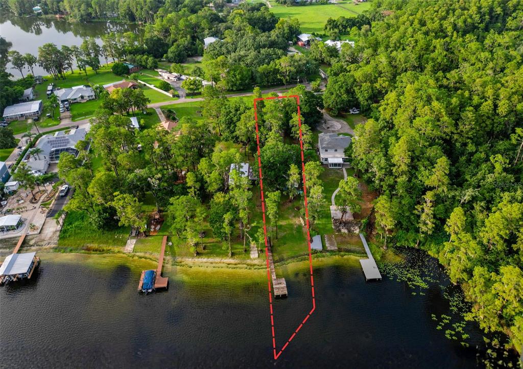 An aerial view shows a waterfront property lot outlined in red with a private dock — 14710 COLOMA LANE, ODESSA, FL