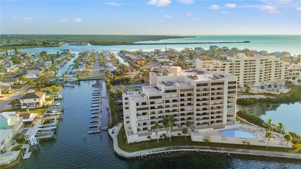 An aerial view of a waterfront condominium complex with a pool and boat docks — 6035 SEA RANCH DRIVE UNIT 415, HUDSON, FL