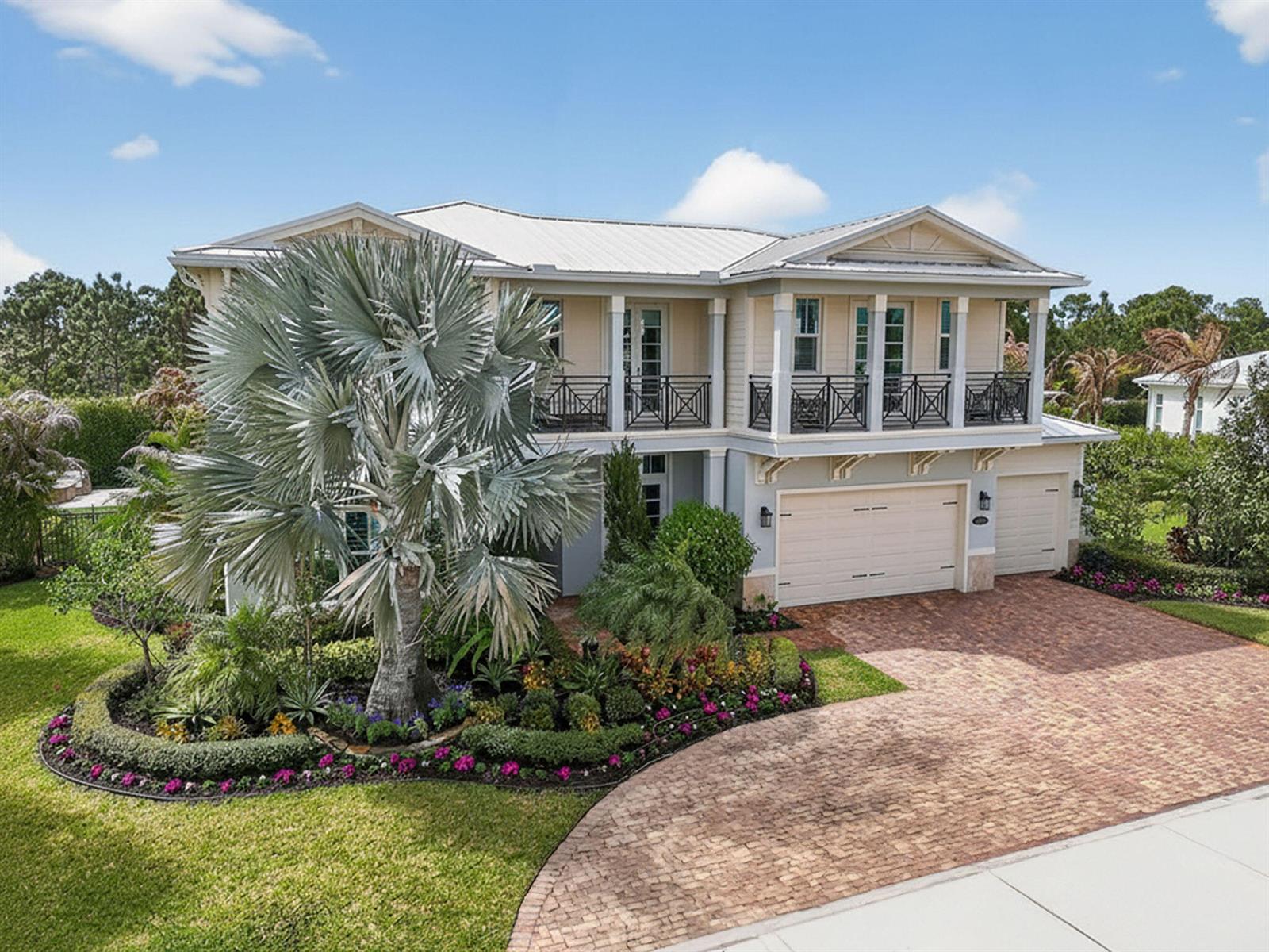 A two-story house with a brick driveway, a large palm tree, and a second-floor balcony — 19966 SE Gallberry Drive, Jupiter FL 33458, JUPITER, FL