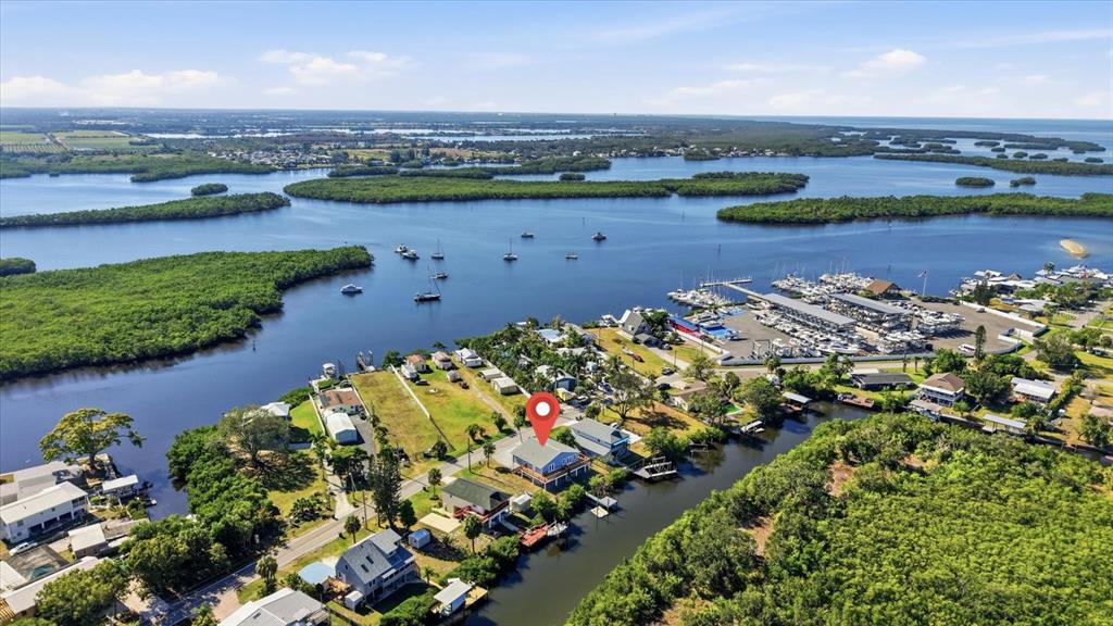 An aerial view shows a waterfront house with a red location pin near a marina — 3303 W SHELL POINT #A ROAD, RUSKIN, FL