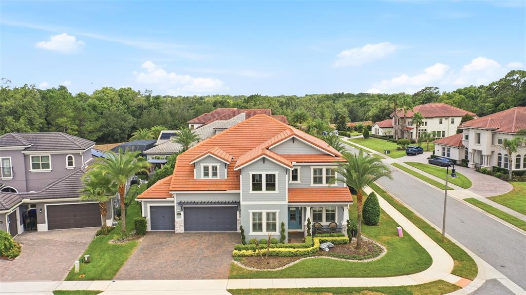 An aerial view shows a two-story suburban house with a red tile roof — 3851 GRASSLAND LOOP, LAKE MARY, FL